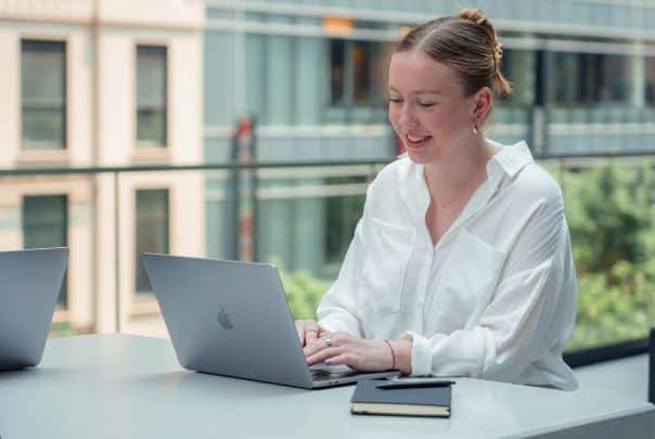 A woman working on her laptop, utilizing PSA software.